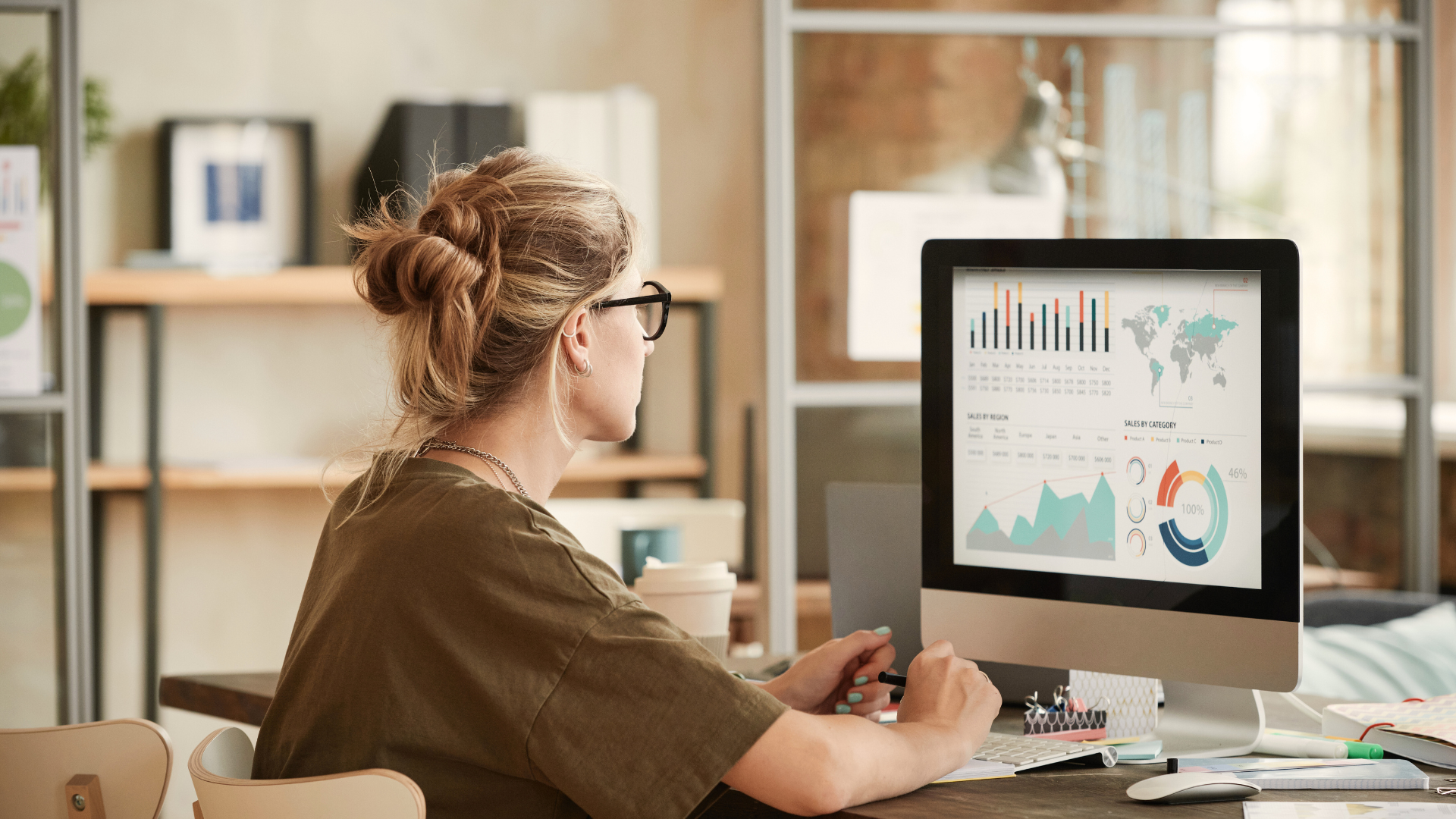 woman looking at computer screen looking at graphs